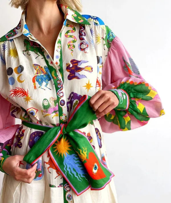Close-up of the multicolor print and green tie belt on the Cersi women's maxi dress