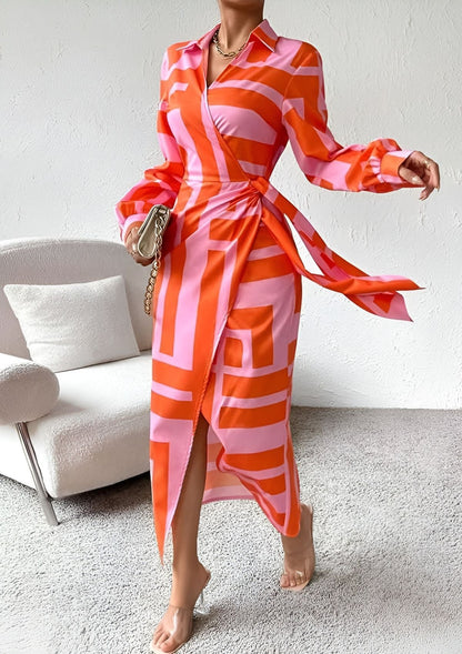 Sassa women's wrap midi dress in orange, front view on model standing by armchair